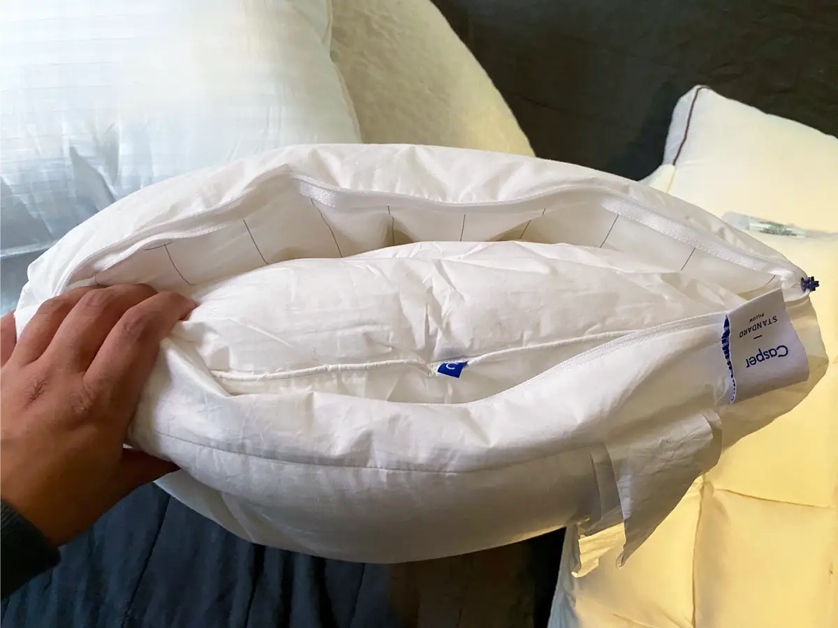 Old flattened pillow next to new fluffy pillow